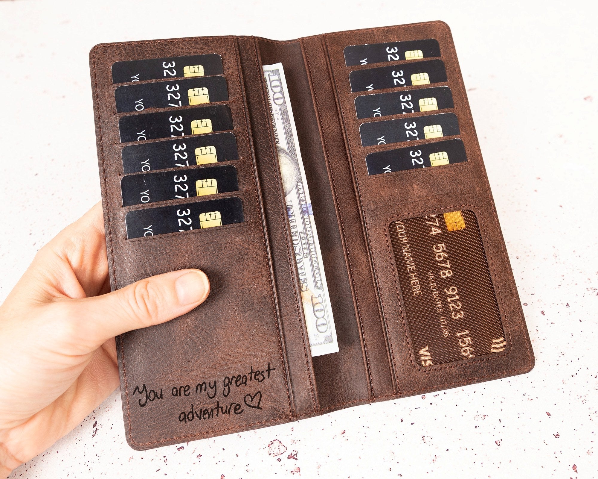 Baseball Long Wallet • Personalized Genuine Leather Wallet - The Lush Gifts - Baseball Long Wallet • Personalized Genuine Leather Wallet - The Lush Gifts - The Lush Gifts - Card Holder - Black - a hand holding a brown wallet with a credit card slot - Customized Leather Gift - Personalized Leather Gift