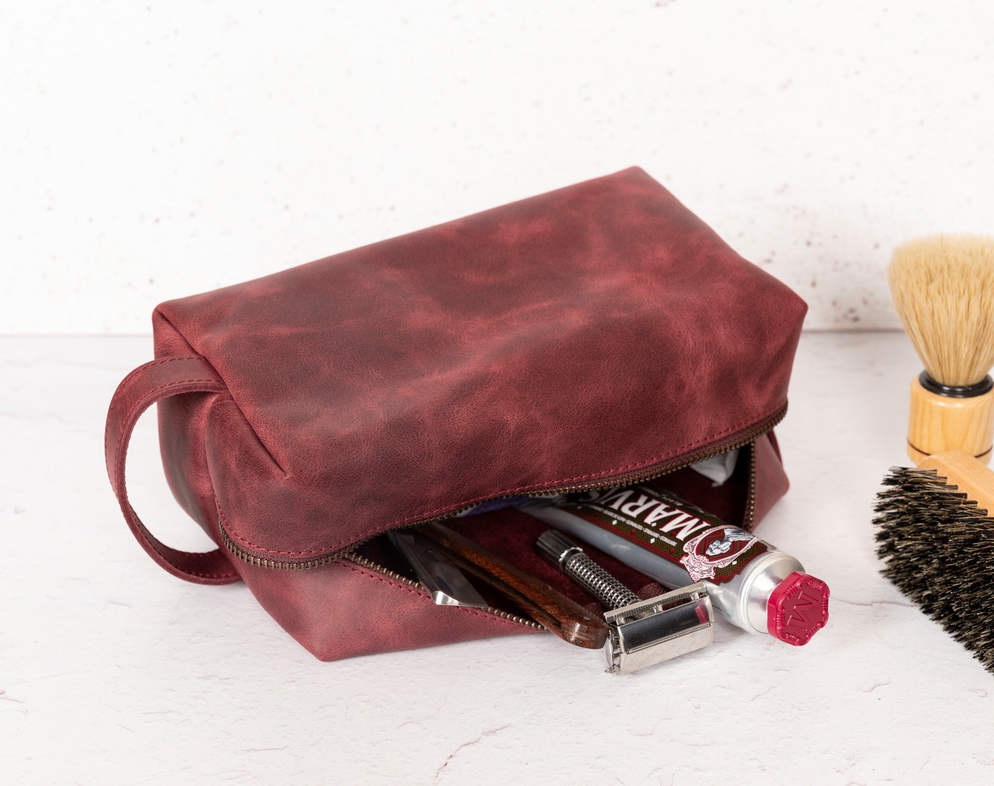 Gym Themed Dopp Kit • Leather Toiletry Bag • Custom Gift - The Lush Gifts - Gym Themed Dopp Kit • Leather Toiletry Bag • Custom Gift - The Lush Gifts - The Lush Gifts - a bag with a brush and other items inside of it - Customized Leather Gift - Personalized Leather Gift