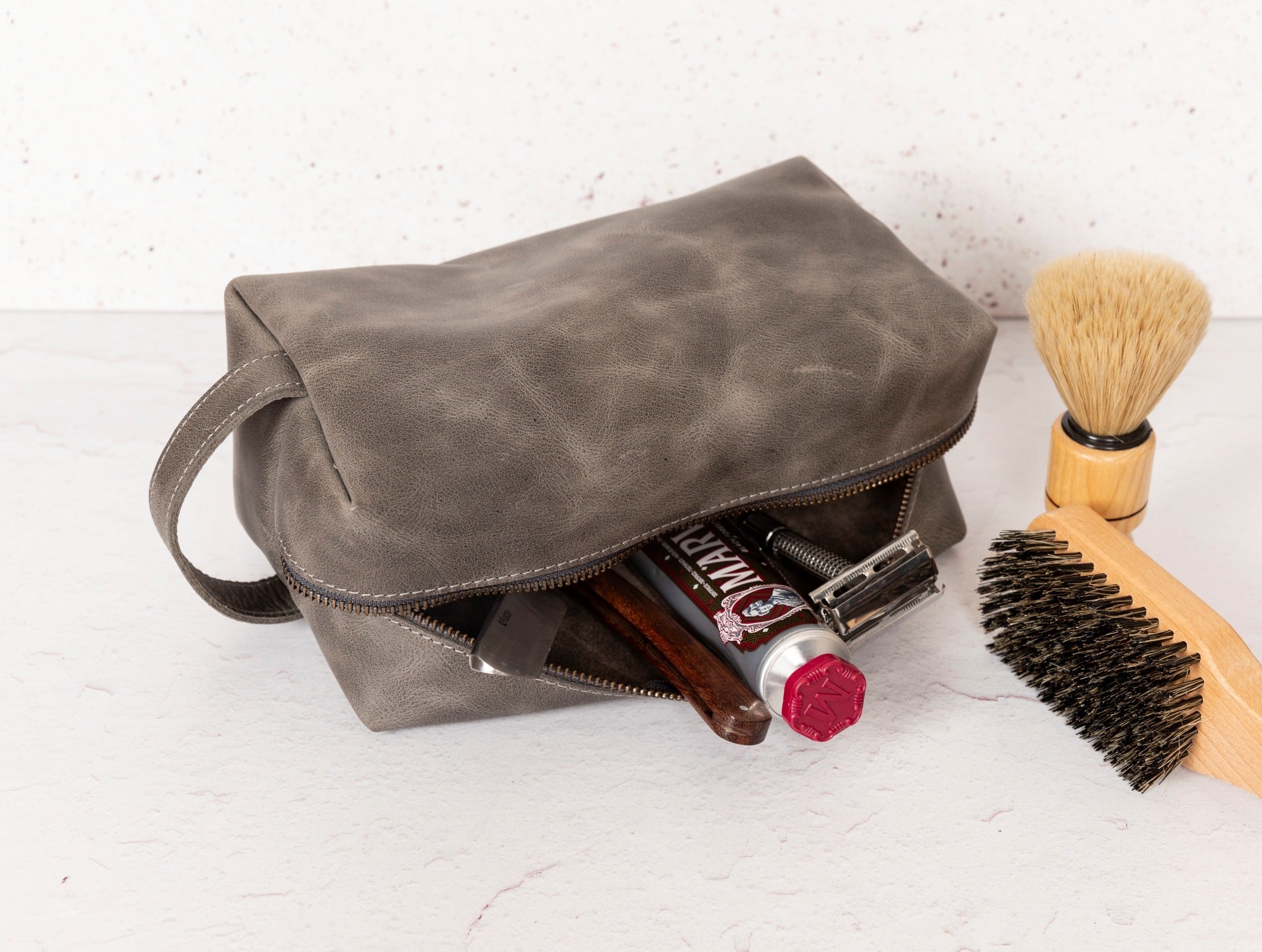 Gym Themed Dopp Kit • Leather Toiletry Bag • Custom Gift - The Lush Gifts - Gym Themed Dopp Kit • Leather Toiletry Bag • Custom Gift - The Lush Gifts - The Lush Gifts - a bag with a brush and other items inside of it - Customized Leather Gift - Personalized Leather Gift