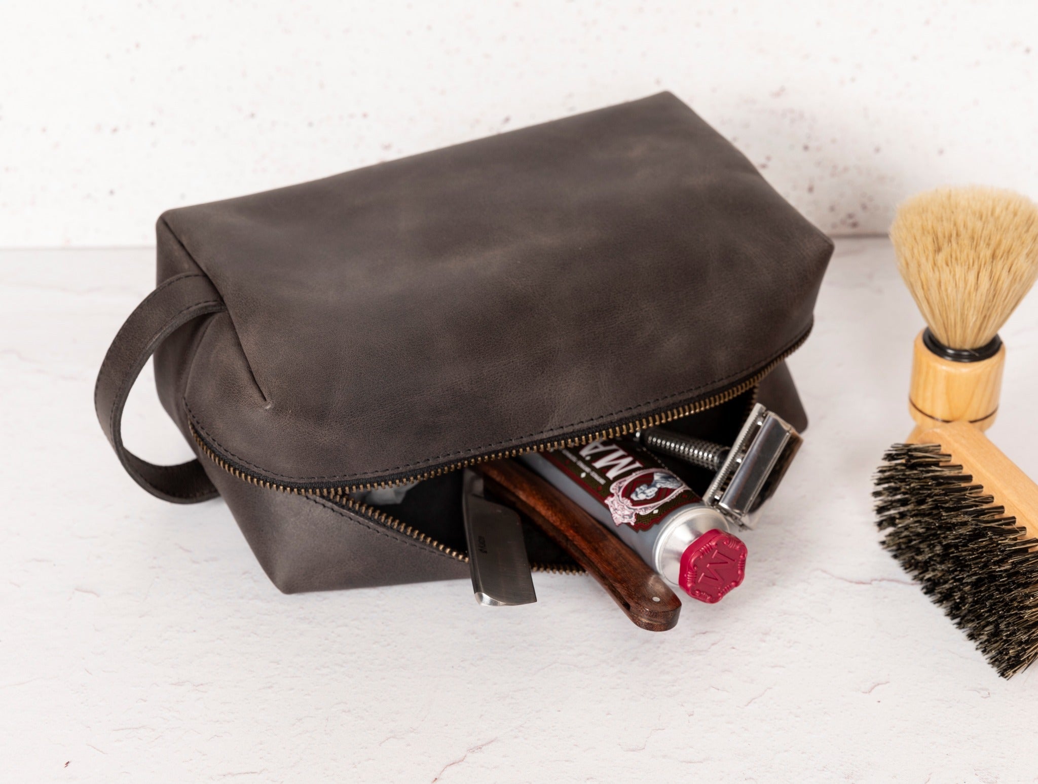 Gym Themed Dopp Kit • Leather Toiletry Bag • Custom Gift - The Lush Gifts - Gym Themed Dopp Kit • Leather Toiletry Bag • Custom Gift - The Lush Gifts - The Lush Gifts - a brown bag with a brush and other items inside of it - Customized Leather Gift - Personalized Leather Gift