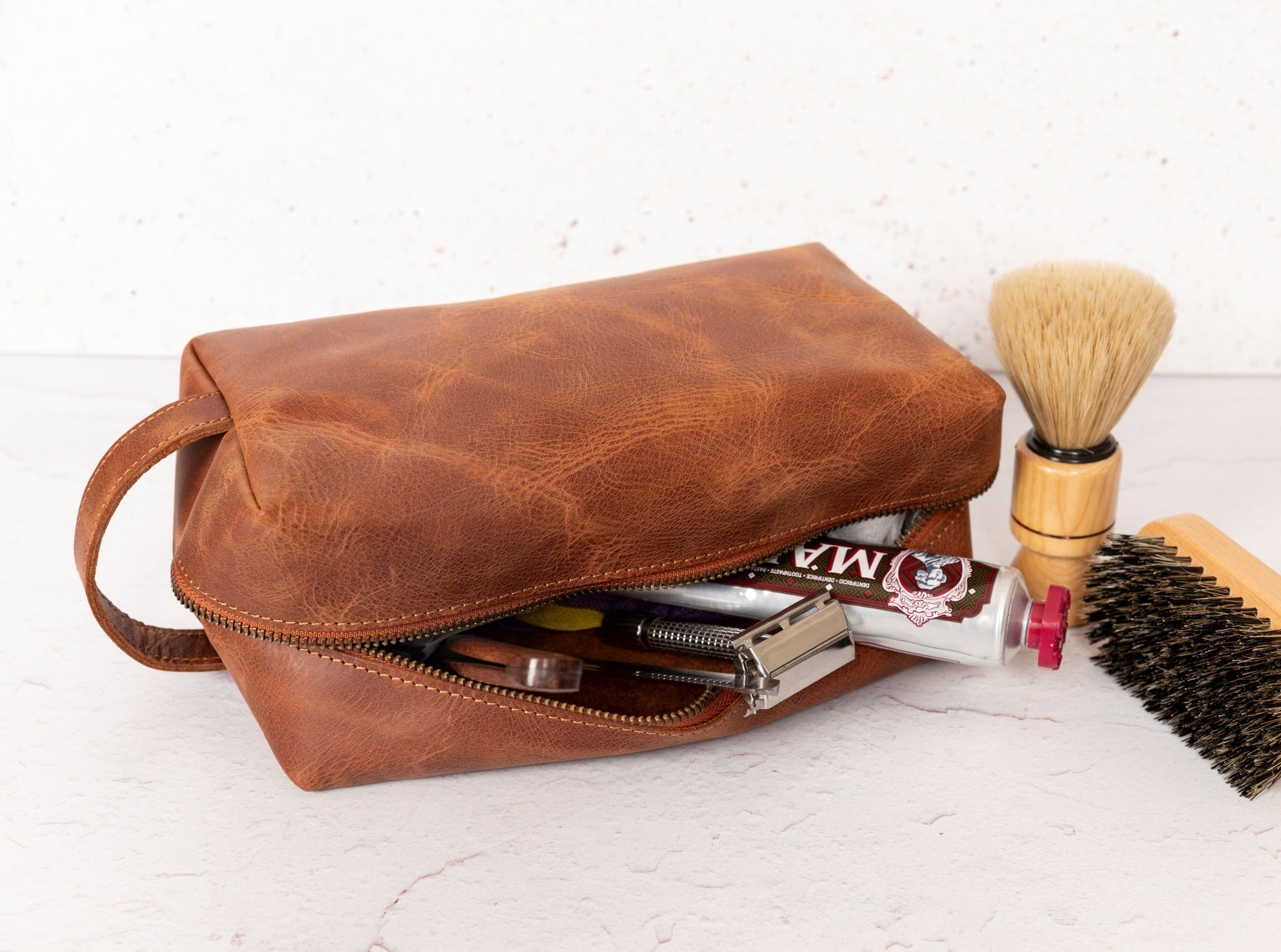 Teacher Themed Dopp Kit • Leather Toiletry Bag • Custom Gift - The Lush Gifts - Teacher Themed Dopp Kit • Leather Toiletry Bag • Custom Gift - The Lush Gifts - The Lush Gifts - a brown bag with a brush and other items inside of it - Customized Leather Gift - Personalized Leather Gift